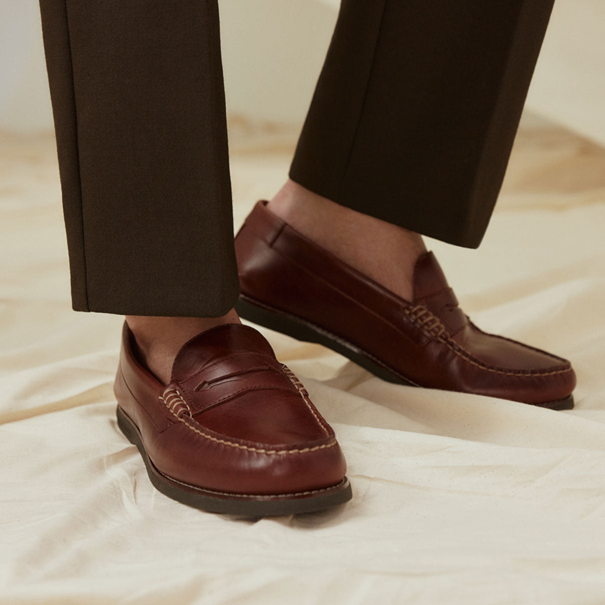 A pair of men's brown loafers against a white background